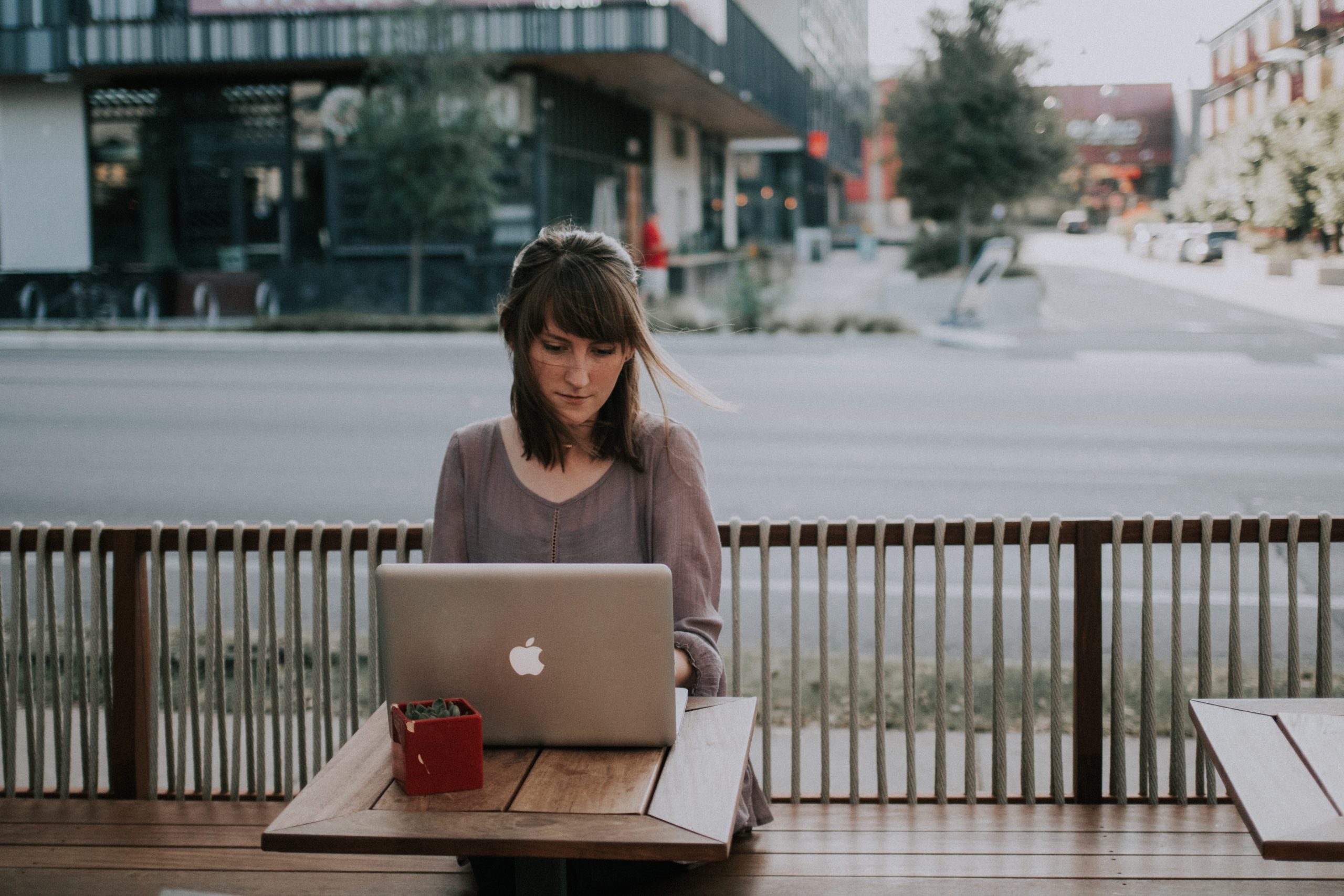 woman on laptop working outside, office conversion
